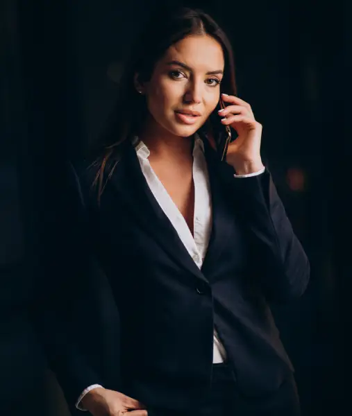 business-woman-talking-phone-staying-late-night-office